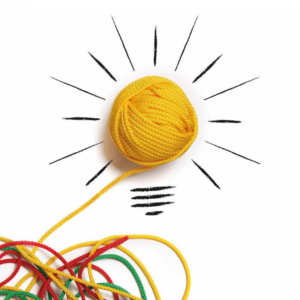 Aus einem verknoteten Wollhaufen entspinnt sich ein sauber aufgerolltes Wollknäuel, dass mit Pinselstrichen zu einer Glühbirne gezeichnet ist. Die Botschaft lautet "Mir geht ein Licht auf!"