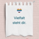 Abreißzettel mit Herz in Regenbogenfarben, darunter der Satz "Vielfalt steht Dir"